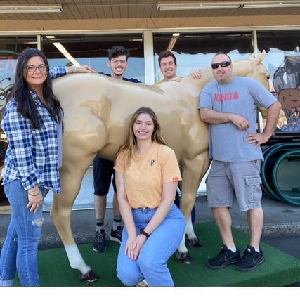 About UsBothell staff in front of a horse statue